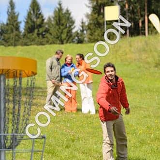 couple-throwing-flying-disc-to-chain-basket-at-springtime-park-SBI-300879319_ComingSoon_v3