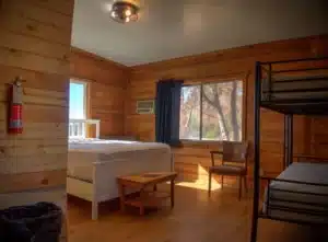 Bunkhouse interior facing beds from entry door